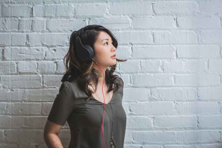 woman looking up while wearing headphones